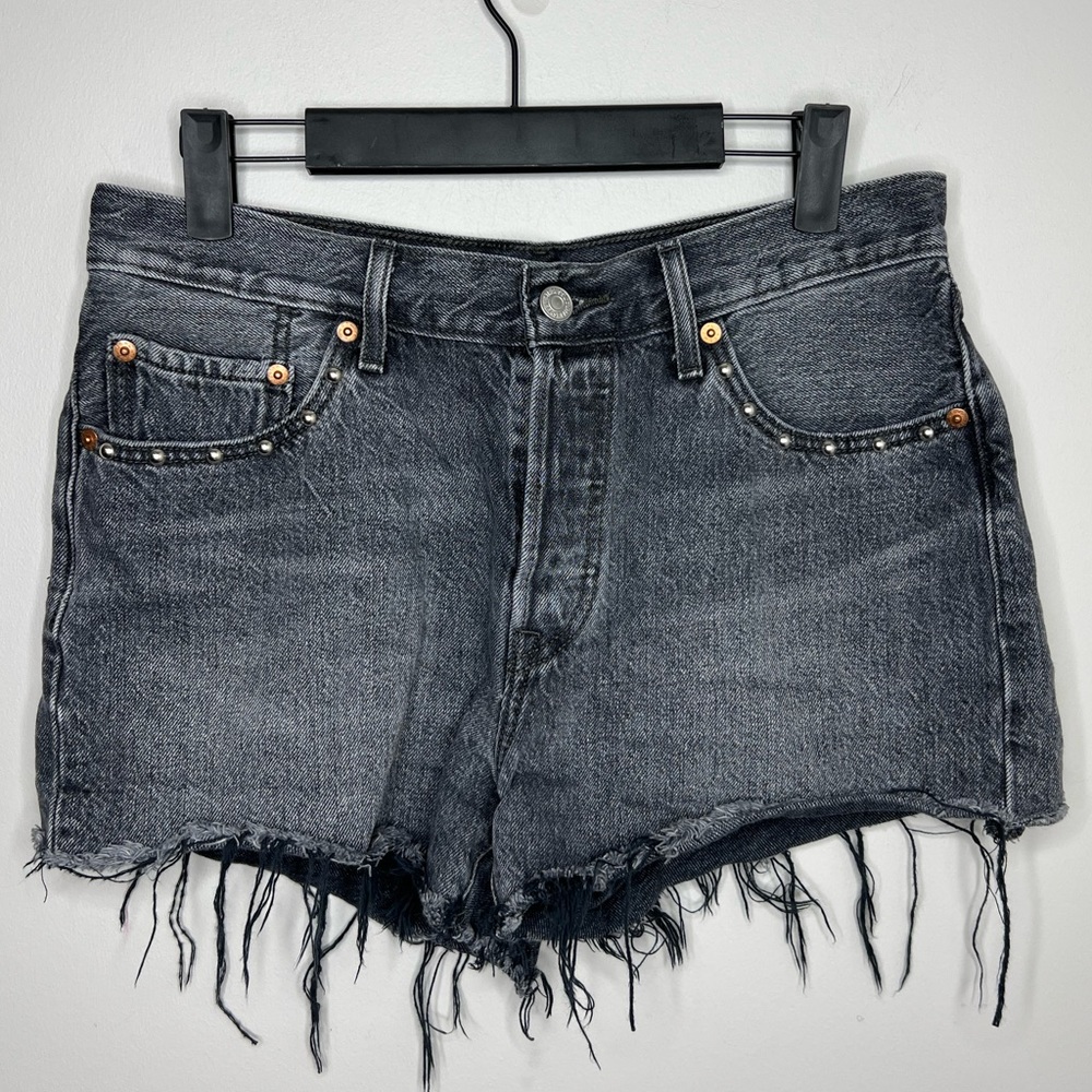 Levi’s high rise distressed black washed jean shots with grommets. Button fly.